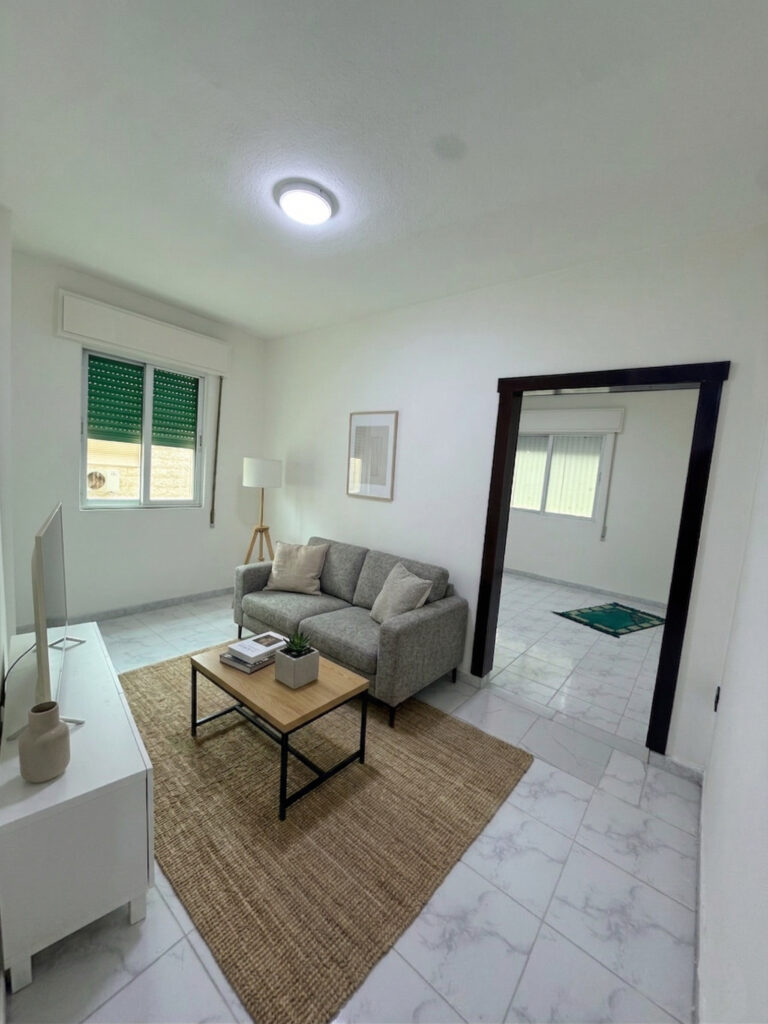 Hallway interior of Apartment D-101 with wooden doors and tiled flooring