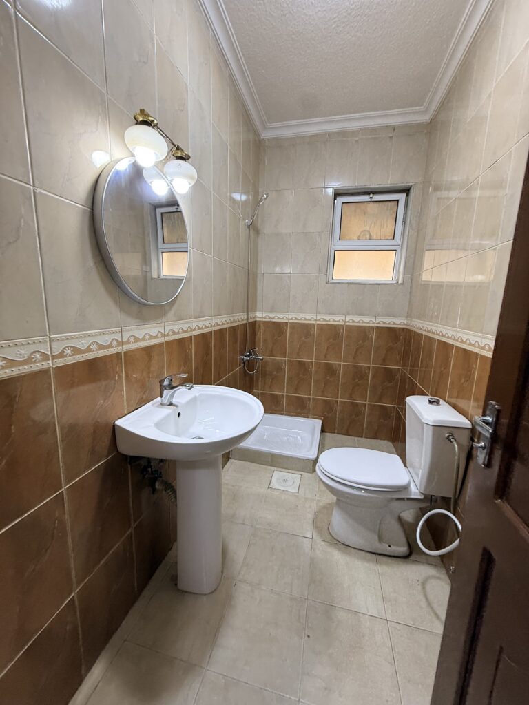 Hallway interior of Apartment D-101 with wooden doors and tiled flooring