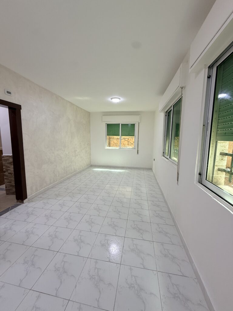 Hallway interior of Apartment D-101 with wooden doors and tiled flooring