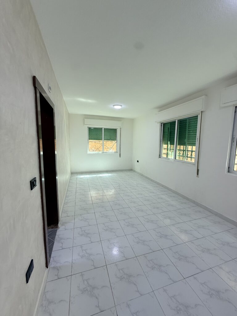 Hallway interior of Apartment D-101 with wooden doors and tiled flooring