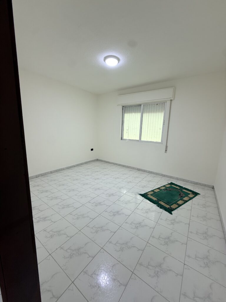 Hallway interior of Apartment D-101 with wooden doors and tiled flooring
